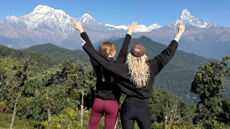 Zwei Reisende mit Blick auf die Annapurna Berge am Australian Base Camp in Nepal