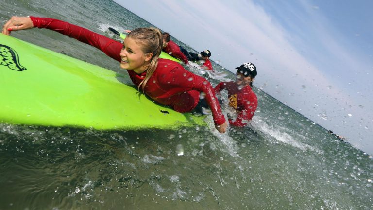 Surfen am Strand von Byron Bay an der Ostüste in Australien traveljunkies Reisen für junge Leute